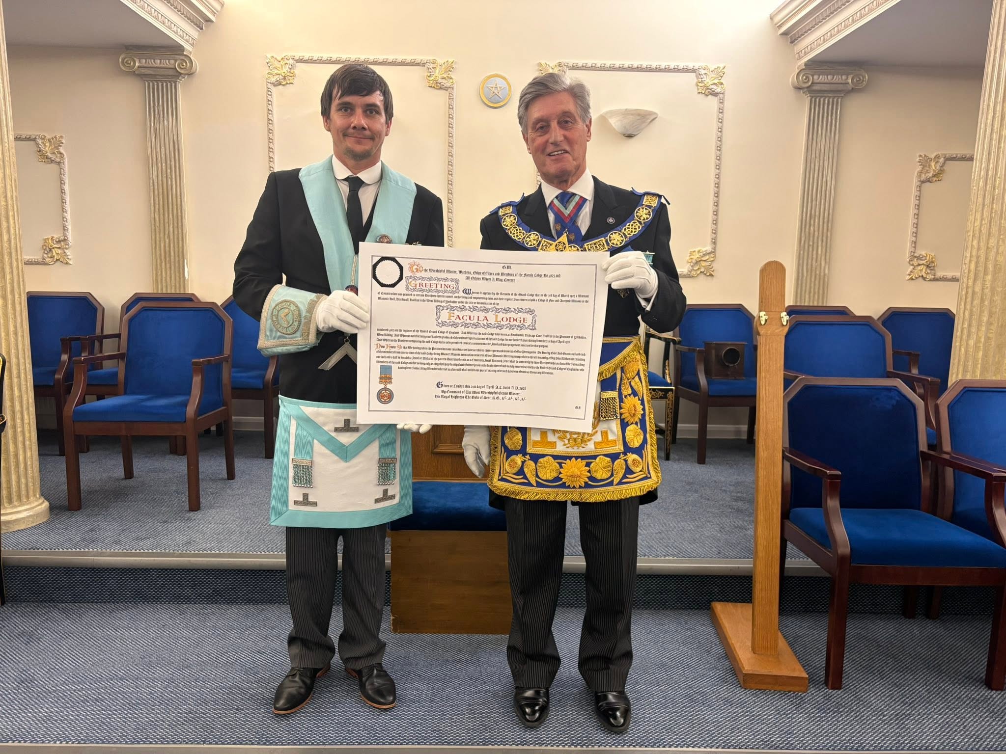 A centenary certificate presentation taking place in the Lodge room