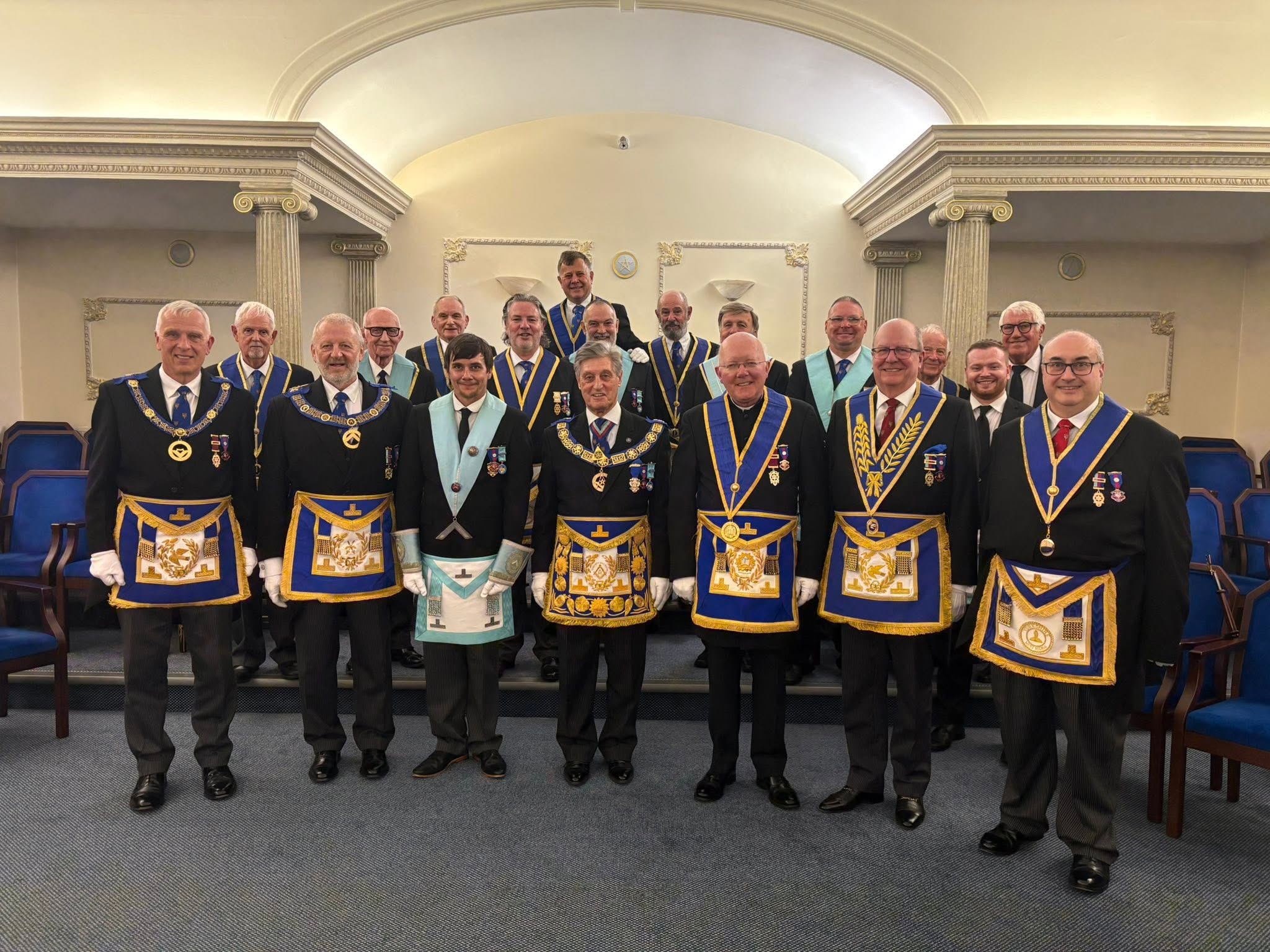 A formal group photograph of Facula Lodge members in the Lodge room